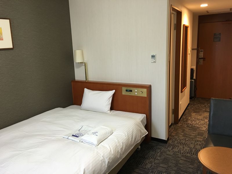 ダイワロイネットホテル富山の禁煙シングルのベッド側
