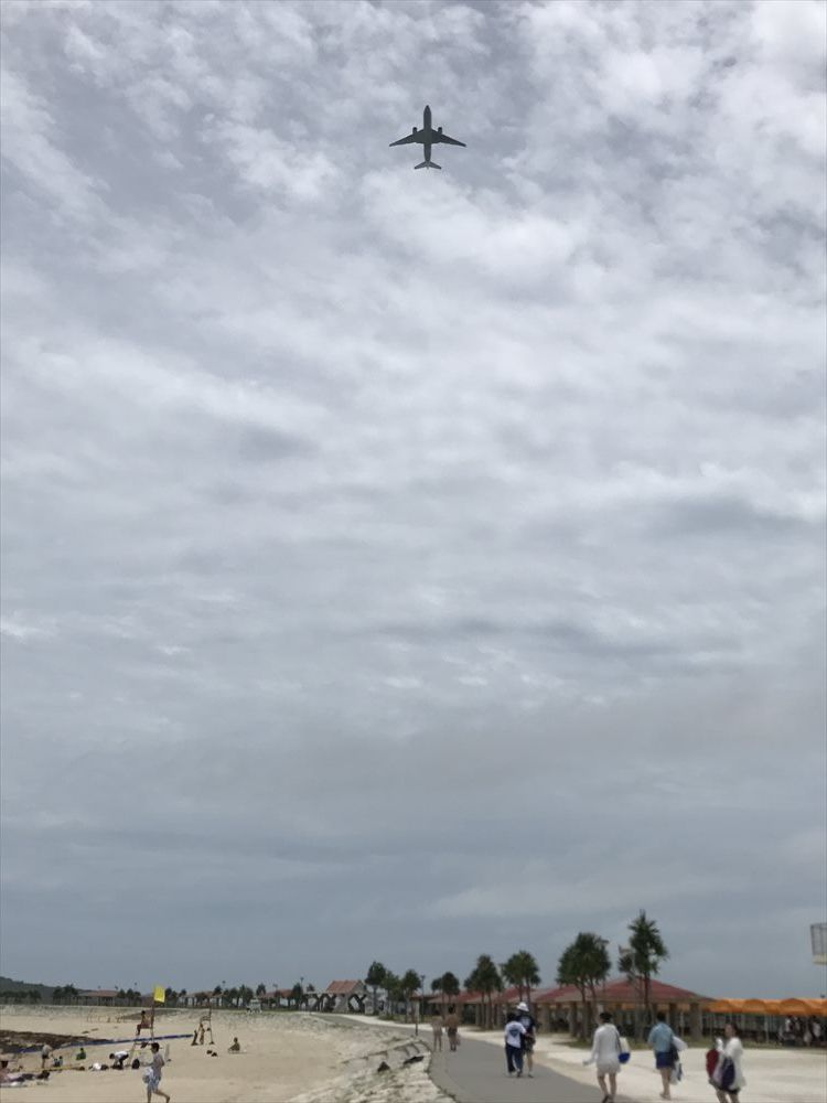 美らSUNビーチで頭上を飛んでいく旅客機